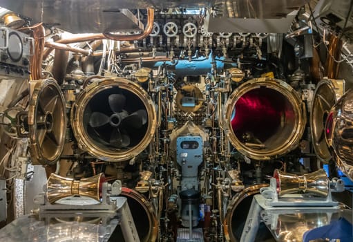 Oahu, Hawaii, USA. - January 10, 2020: Pearl Harbor. Closeup of 2 open Torpedo tubes in long submarine USS Bowfin. One loaded. Lots of handles and gold colored machinery.