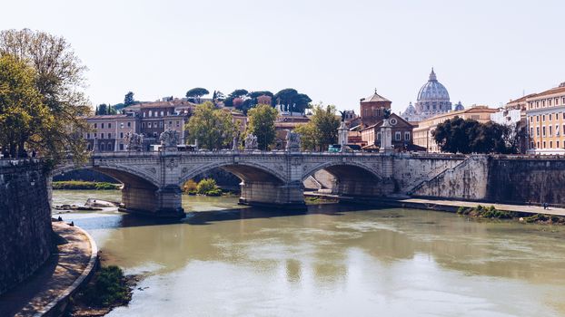 Skyline with bridge Ponte Vittorio Emanuele II and classic architecture in Rome, Vatican City scenery over Tiber river.