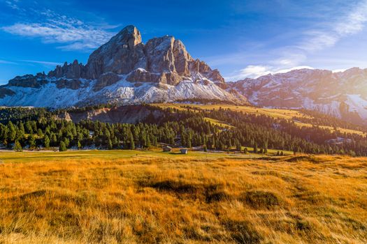 Stunning view of Peitlerkofel mountain from Passo delle Erbe in Dolomites, Italy. View of Sass de Putia (Peitlerkofel) at Passo delle Erbe, with wooden farm houses, Dolomites, South Tyrol, Italy.