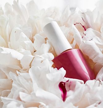 Nail polish bottles on floral background, french manicure and cosmetic branding design