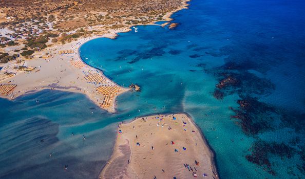 Aerial view of beautiful tropical Elafonissi Beach with pink sand. View of a nice tropical Elafonissi beach from the air. Beautiful sky, sea, resort. Elafonissi beach, Crete, Greece.