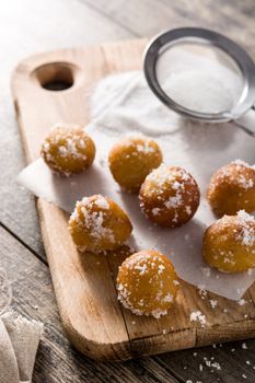 Carnival fritters or buñuelos de viento for holy week on wooden table