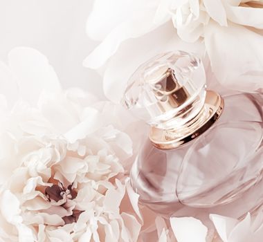 Fragrance bottle as luxury perfume product on background of peony flowers, parfum ad and beauty branding design