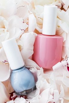 Nail polish bottles on floral background, french manicure and cosmetic branding design