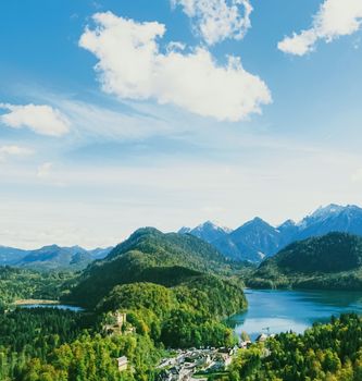 Beautiful nature of European Alps, landscape view of alpine mountains, lake and village in spring season, travel and destination scenery