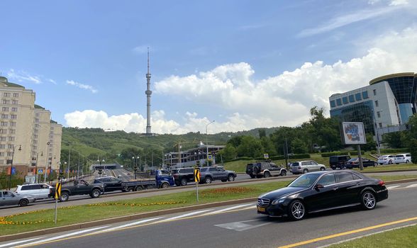 Almaty, Kazakhstan - June 1, 2020: Kok Tobe telecommunication tower and buildings along Dostyk Avenue.