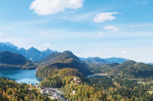 Beautiful nature of European Alps, landscape view of alpine mountains, lake and village on a sunny day, travel and destination scenery