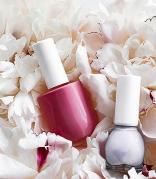 Nail polish bottles on floral background, french manicure and cosmetic branding design