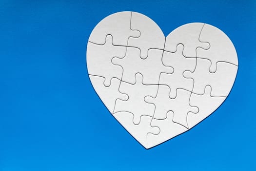 Heart object made of puzzle pieces. Make complete heart. Jigsaw puzzle pieces in form of heart. Happy Valentines Day, greeting card template. Heart jigsaw puzzle.