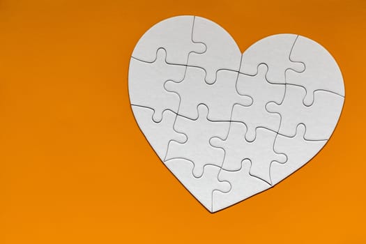 Heart object made of puzzle pieces. Make complete heart. Jigsaw puzzle pieces in form of heart. Happy Valentines Day, greeting card template. Heart jigsaw puzzle.