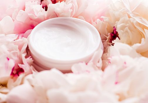 Luxe cosmetic cream jar as antiaging skincare routine product on background of peony flowers, body moisturizer and beauty branding design