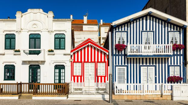 Street with colorful houses in Costa Nova, Aveiro, Portugal. Street with striped houses, Costa Nova, Aveiro, Portugal. Facades of colorful houses in Costa Nova, Aveiro, Portugal.