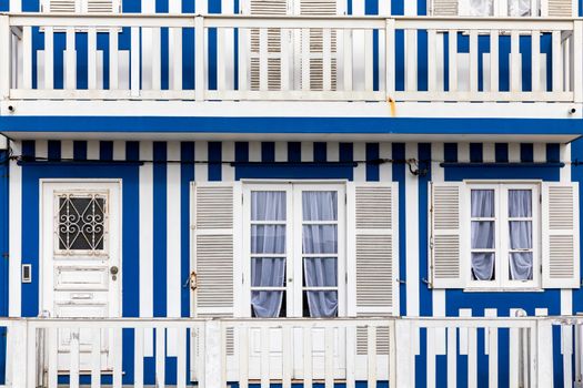 Street with colorful houses in Costa Nova, Aveiro, Portugal. Street with striped houses, Costa Nova, Aveiro, Portugal. Facades of colorful houses in Costa Nova, Aveiro, Portugal.