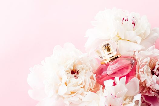 Luxurious fragrance bottle as chic perfume product on background of peony flowers, parfum ad and beauty branding design