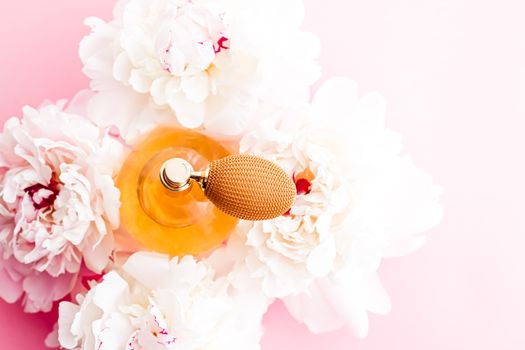 Chic fragrance bottle as citrus perfume product on background of peony flowers, parfum ad and beauty branding design