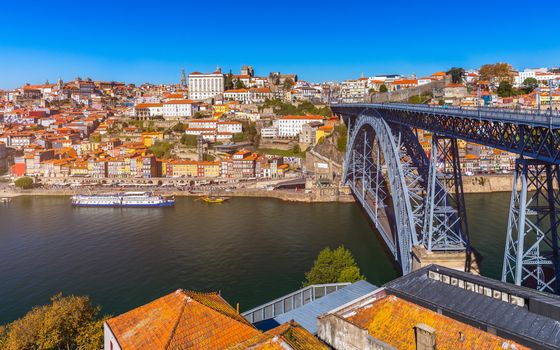 Colorful houses of Porto Ribeira, traditional facades, old multi-colored houses with red roof tiles on the embankment in the city of Porto, Portugal