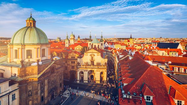 Scenic summer aerial panorama of the Old Town architecture in Prague, Czech Republic. Red roof tiles panorama of Prague old town.  Prague Old Town Square houses with traditional red roofs. Czechia.