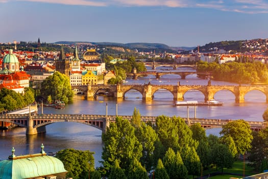 Scenic view of the Old Town pier architecture and Charles Bridge over Vltava river in Prague, Czech Republic. Prague iconic Charles Bridge (Karluv Most) and Old Town Bridge Tower at sunset, Czechia.