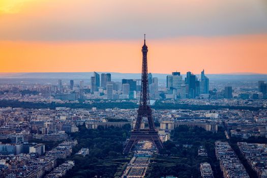 View of Paris with Eiffel Tower from Montparnasse building. Eiffel tower view from Montparnasse at sunset, view of the Eiffel Tower and La Defense district in Paris, France.