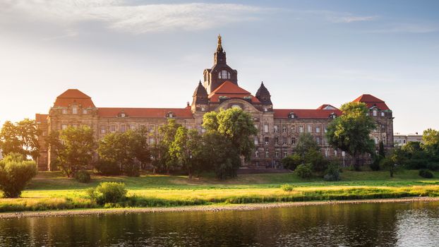 Incredible evening panorama of Cathedral of the Holy Trinity or Hofkirche, Bruehl's Terrace or The Balcony of Europe. Dramatic autumn sunset on Elbe river in Dresden, Saxony, Germany, Europe.