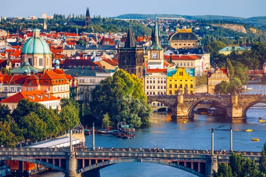 Scenic view of the Old Town pier architecture and Charles Bridge over Vltava river in Prague, Czech Republic. Prague iconic Charles Bridge (Karluv Most) and Old Town Bridge Tower at sunset, Czechia.