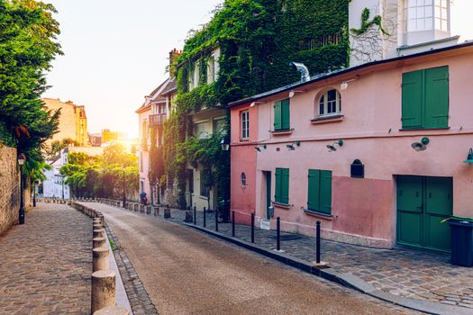 Montmartre district of Paris. Houses on narrow road in Montmartre district of Paris. View of cozy street in quarter Montmartre in Paris, France. Architecture and landmarks of Paris. Postcard of Paris.