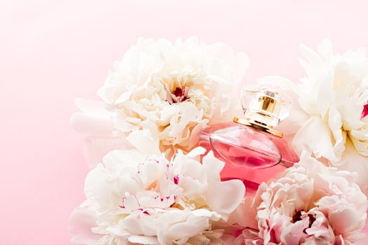 Luxurious fragrance bottle as chic perfume product on background of peony flowers, parfum ad and beauty branding design