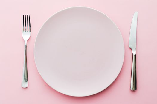 Empty plate and cutlery as mockup set on pink background, top tableware for chef table decor and menu branding design