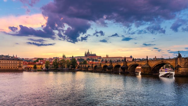 Prague Castle, Charles Bridge and boats on the Vltava river. View of Hradcany Prague Castle, Charles Bridge and a boats on the Vltava river in the capital of the Czechia. Boat cruise on Vltava river.