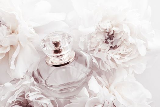 Chic fragrance bottle as luxe perfume product on background of peony flowers, parfum ad and beauty branding design