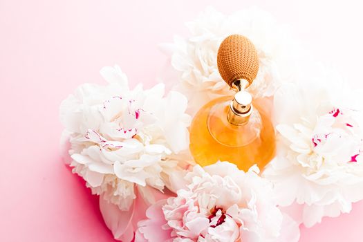 Chic fragrance bottle as citrus perfume product on background of peony flowers, parfum ad and beauty branding design