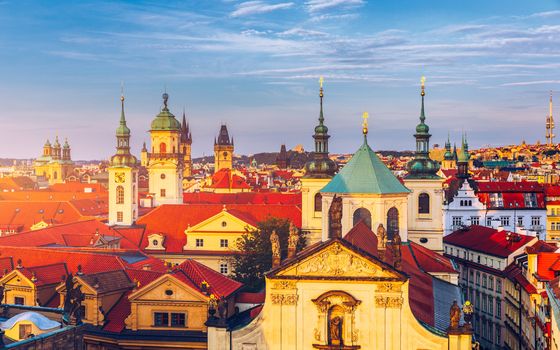 Scenic summer aerial panorama of the Old Town architecture in Prague, Czech Republic. Red roof tiles panorama of Prague old town.  Prague Old Town Square houses with traditional red roofs. Czechia.
