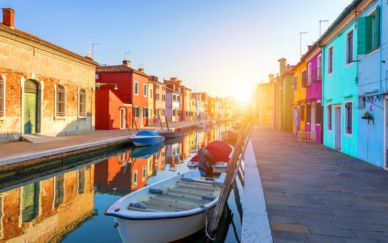 Street with colorful buildings in Burano island, Venice, Italy. Architecture and landmarks of Burano, Venice postcard. Scenic canal and colorful architecture in Burano island near Venice, Italy