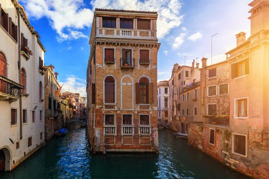 Street canal in Venice, Italy. Narrow canal among old colorful brick houses in Venice, Italy. Venice postcard