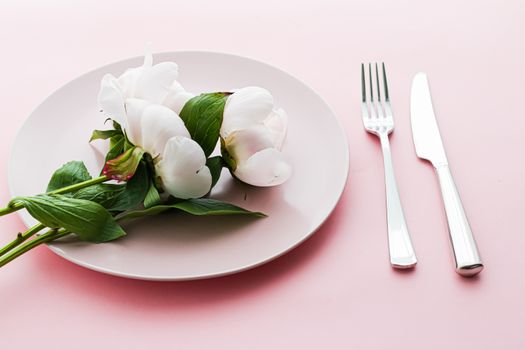 Dining plate and cutlery with peony flowers as wedding decor set on pink background, top tableware for event decoration and menu branding design