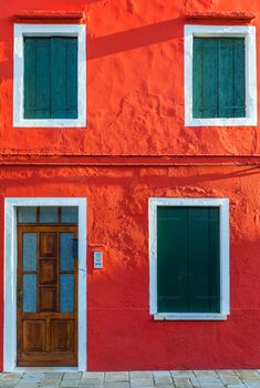 Lovely house facade and colorful walls in Burano, Venice. Burano island canal, colorful houses and boats, Venice landmark, Italy. Europe