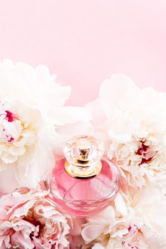 Luxurious fragrance bottle as chic perfume product on background of peony flowers, parfum ad and beauty branding design