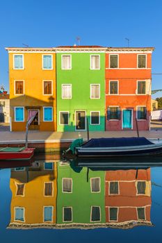 Lovely house facade and colorful walls in Burano, Venice. Burano island canal, colorful houses and boats, Venice landmark, Italy. Europe