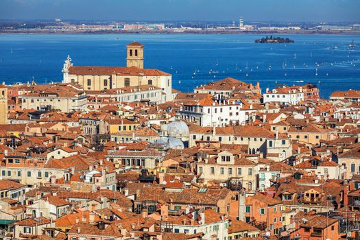 Venice panoramic aerial view with red roofs, Veneto, Italy. Aerial view with dense medieval red roofs of Venice, Italy 