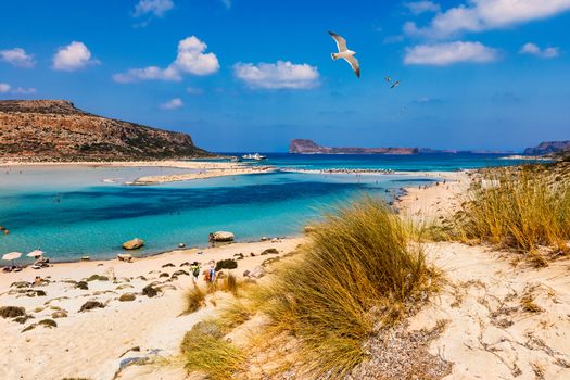 Balos Lagoon and Gramvousa island on Crete with seagulls flying over, Greece. Cap tigani in the center. Balos beach on Crete island, Greece. Crystal clear water of Balos beach.