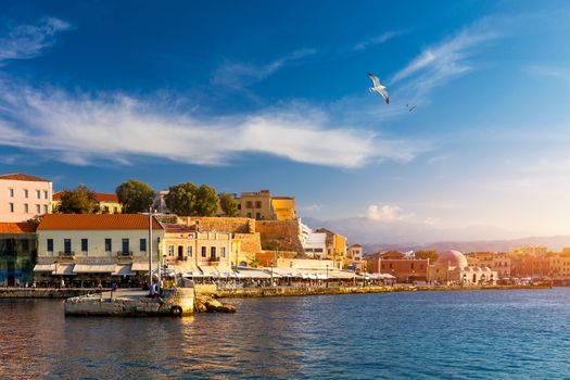 Old port of Chania with flying seagulls. Landmarks of Crete island. Bay of Chania at sunny summer day, Crete Greece. View of the old port of Chania, Crete, Greece. The port of chania, or Hania. 