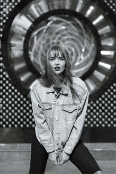 Lifestyle shot of wonderful young woman with red lips wears jeans jacket. Monochrome color