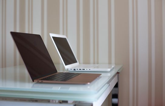 Two laptops on the kitchen's table. Home workspace for self isolation time