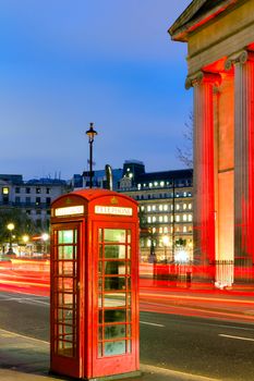 London Telephone box at night with streaming vehicle headlights