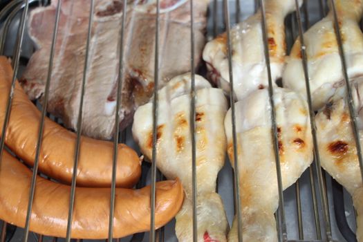 mixed meat grill with chicken and sausage cooked at barbecue