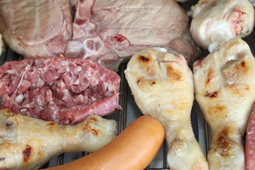 mixed meat grill with chicken and sausage cooked at barbecue