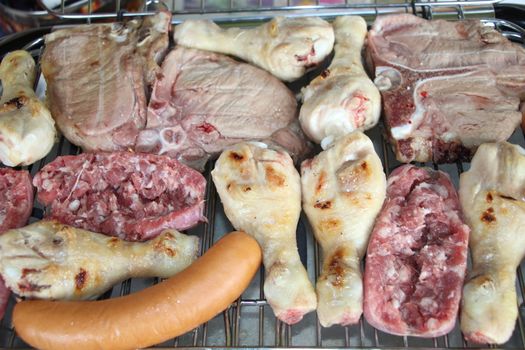 mixed meat grill with chicken and sausage cooked at barbecue