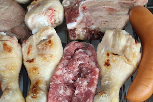 mixed meat grill with chicken and sausage cooked at barbecue