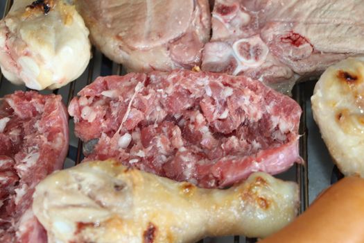 mixed meat grill with chicken and sausage cooked at barbecue