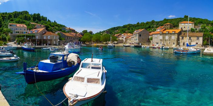 SUDURAD, CROATIA - JUNE 27, 2015: Scene of the fishing port, with boats, locals and tourists, in the village Sudurad, Sipan Island, one of the Elaphiti Islands, Croatia